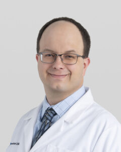 John Metzcar, President of AMEND USA in a lab coat, blue shirt, and tie.