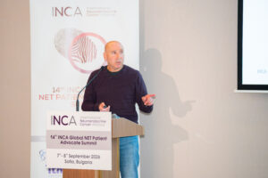 Board Member Thomas Lehrich presents behind a podium at INCA Global Summit 2026